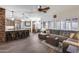 Open concept living room featuring a stone kitchen island, wood floors, and a comfortable sofa at 8246 W Melinda Ln, Peoria, AZ 85382