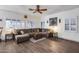 Cozy living room with wood floors, large sectional sofa, and Route 66 decor at 8246 W Melinda Ln, Peoria, AZ 85382
