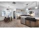 Open floor plan featuring kitchen island, dining table, and living area with many windows at 8246 W Melinda Ln, Peoria, AZ 85382