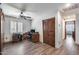 Spacious home office with wood floors, barn door closet, and natural light at 8246 W Melinda Ln, Peoria, AZ 85382