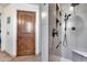 Contemporary shower with gray tile, a sleek shower head, and decorative built in shelving at 8246 W Melinda Ln, Peoria, AZ 85382