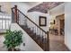Staircase with stone accent wall, wrought iron railing, and a view of the living room at 8246 W Melinda Ln, Peoria, AZ 85382