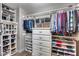 Well-organized walk-in closet with custom shelving and ample storage space for clothes and shoes at 8246 W Melinda Ln, Peoria, AZ 85382