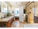 Elegant bathroom featuring a stone shower, dual vanity, and view into the primary bedroom at 13802 N 64Th Pl, Scottsdale, AZ 85254
