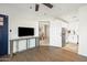A bright living room features wood floors and open access to the kitchen at 13802 N 64Th Pl, Scottsdale, AZ 85254