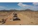 Aerial view of new construction homes in the desert landscape, surrounded by mountains and blue skies at 6023 N Nigal Rd, Casa Grande, AZ 85122