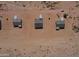 Birds-eye view of desert homes featuring red dirt landscape, brown roofs, and concrete driveways at 6023 N Nigal Rd, Casa Grande, AZ 85122