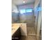 Modern bathroom showcasing a glass-enclosed shower with stylish tile, quartz counters, and contemporary fixtures at 6023 N Nigal Rd, Casa Grande, AZ 85122