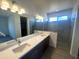 Bathroom features double vanity with quartz countertops, modern fixtures, and a glass-enclosed shower with tile accents at 6023 N Nigal Rd, Casa Grande, AZ 85122