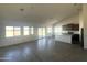 Open floor plan reveals the kitchen, complete with an island and stainless steel appliances, and tile floor throughout at 6023 N Nigal Rd, Casa Grande, AZ 85122