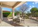 Inviting covered patio with an outdoor kitchen, built-in grill, and comfortable seating area for entertaining at 7723 E Visao Dr, Scottsdale, AZ 85266