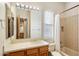 Bathroom with large mirror, vanity, and shower-tub combination in a well-lit space at 7723 E Visao Dr, Scottsdale, AZ 85266