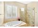 Bathroom with soaking tub and tiled shower, offering a relaxing space at 7723 E Visao Dr, Scottsdale, AZ 85266