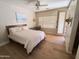Well-lit bedroom with wood floors, a cozy bed, and tasteful decor for a comfortable living space at 7723 E Visao Dr, Scottsdale, AZ 85266