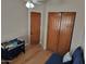 Bedroom room with baby crib, closet, and an open door showing the wood flooring at 7723 E Visao Dr, Scottsdale, AZ 85266