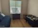 Bedroom with blue daybed and baby crib next to a window with plenty of natural light at 7723 E Visao Dr, Scottsdale, AZ 85266