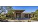 Elegant clubhouse entrance with stone accents, lush landscaping, and welcoming architectural details at 7723 E Visao Dr, Scottsdale, AZ 85266