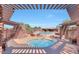Relaxing community pool area with lounge chairs, covered seating, spa, and lush desert landscaping at 7723 E Visao Dr, Scottsdale, AZ 85266