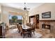 Bright dining room features a fireplace and built in shelving with views to the backyard at 7723 E Visao Dr, Scottsdale, AZ 85266