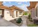 Charming home exterior with stone pathway, lush landscaping, and architectural details enhancing its appeal at 7723 E Visao Dr, Scottsdale, AZ 85266
