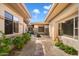 Charming courtyard with stone pathway, manicured landscaping, and a tranquil seating area at 7723 E Visao Dr, Scottsdale, AZ 85266