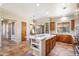 Open kitchen with stainless appliances, wood cabinetry, and a spacious center island at 7723 E Visao Dr, Scottsdale, AZ 85266