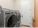 Laundry room with a front-load washer and dryer set and neutral wall color at 7723 E Visao Dr, Scottsdale, AZ 85266