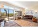 Spacious living room featuring large windows, hardwood floors, and outdoor views at 7723 E Visao Dr, Scottsdale, AZ 85266