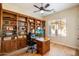 Office space with built in book cases and wood desk in a well-lit space at 7723 E Visao Dr, Scottsdale, AZ 85266