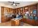 Spacious home office featuring extensive built-in shelving and a large desk for productivity and organization at 7723 E Visao Dr, Scottsdale, AZ 85266