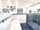 Bright bathroom featuring a sleek vanity, decorative tile accents, and glass-enclosed shower with blue-tiled floor at 10223 N 40Th Ave, Phoenix, AZ 85051