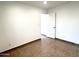 Tiled bedroom with neutral walls, white trim, and an open doorway to another room at 10223 N 40Th Ave, Phoenix, AZ 85051