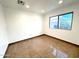 Bright and airy bedroom with neutral walls, tiled floor, and plenty of natural light from the window at 10223 N 40Th Ave, Phoenix, AZ 85051