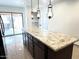 Kitchen island with granite countertops, dark wood cabinetry, and pendant lighting above at 10223 N 40Th Ave, Phoenix, AZ 85051