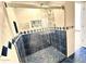 Close up on glass-enclosed shower stall featuring blue tile accents and blue tiled floor at 10223 N 40Th Ave, Phoenix, AZ 85051