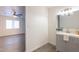 View from bedroom of a bathroom featuring a grey vanity and a tiled floor at 10828 N Biltmore Dr # 113, Phoenix, AZ 85029