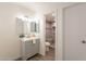 Bathroom vanity with a white sink, grey cabinets, and a view into the tiled shower at 10828 N Biltmore Dr # 113, Phoenix, AZ 85029