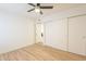This bedroom has wood-look tile floors and a closet with white sliding doors at 10828 N Biltmore Dr # 113, Phoenix, AZ 85029