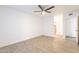 Light and bright bedroom with wood-look flooring, ceiling fan, and access to ensuite bathroom at 10828 N Biltmore Dr # 113, Phoenix, AZ 85029