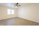 The bedroom features wood-look flooring and a window with a view to the outside at 10828 N Biltmore Dr # 113, Phoenix, AZ 85029