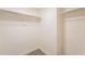 Walk-in closet with white walls, new tile flooring and closet rods at 10828 N Biltmore Dr # 113, Phoenix, AZ 85029