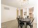 Bright dining area features stylish lighting, a round table, and access to the updated kitchen at 10828 N Biltmore Dr # 113, Phoenix, AZ 85029