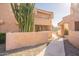 Exterior view of complex with a pathway and desert landscaping, showing the architectural style at 10828 N Biltmore Dr # 113, Phoenix, AZ 85029