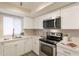 Updated kitchen featuring stainless steel appliances, white cabinets, and subway tile backsplash at 10828 N Biltmore Dr # 113, Phoenix, AZ 85029