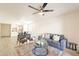 Bright living room with contemporary ceiling fan, stylish furniture, and a view into the dining area at 10828 N Biltmore Dr # 113, Phoenix, AZ 85029