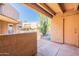 Private patio offering a glimpse of the desert landscaping and the complex's architectural style at 10828 N Biltmore Dr # 113, Phoenix, AZ 85029