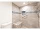Bathroom shower featuring beautiful tile, a shower bench, and shower fixtures at 10828 N Biltmore Dr # 113, Phoenix, AZ 85029