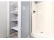 A bathroom with shelves in the doorway and a shower with a glass door at 1225 N 36Th St # 2081, Phoenix, AZ 85008
