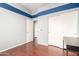 A spacious room with wood flooring, a closet, and neutral wall paint at 1225 N 36Th St # 2081, Phoenix, AZ 85008