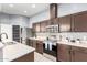 Well-equipped kitchen with stainless steel appliances and tile backsplash at 1225 N 36Th St # 2081, Phoenix, AZ 85008
